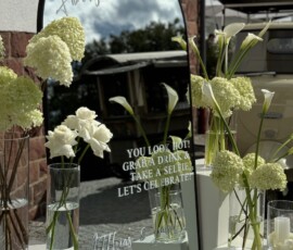 Ein eleganter Empfang für die Gäste: moderner Hochzeitsspiegel mit weißen Blütenarrangements von der Gärtnerei Reinwald. Moderner Hochzeitsspiegel mit weißer Blumendekoration aus Hortensien, Rosen und Calla.